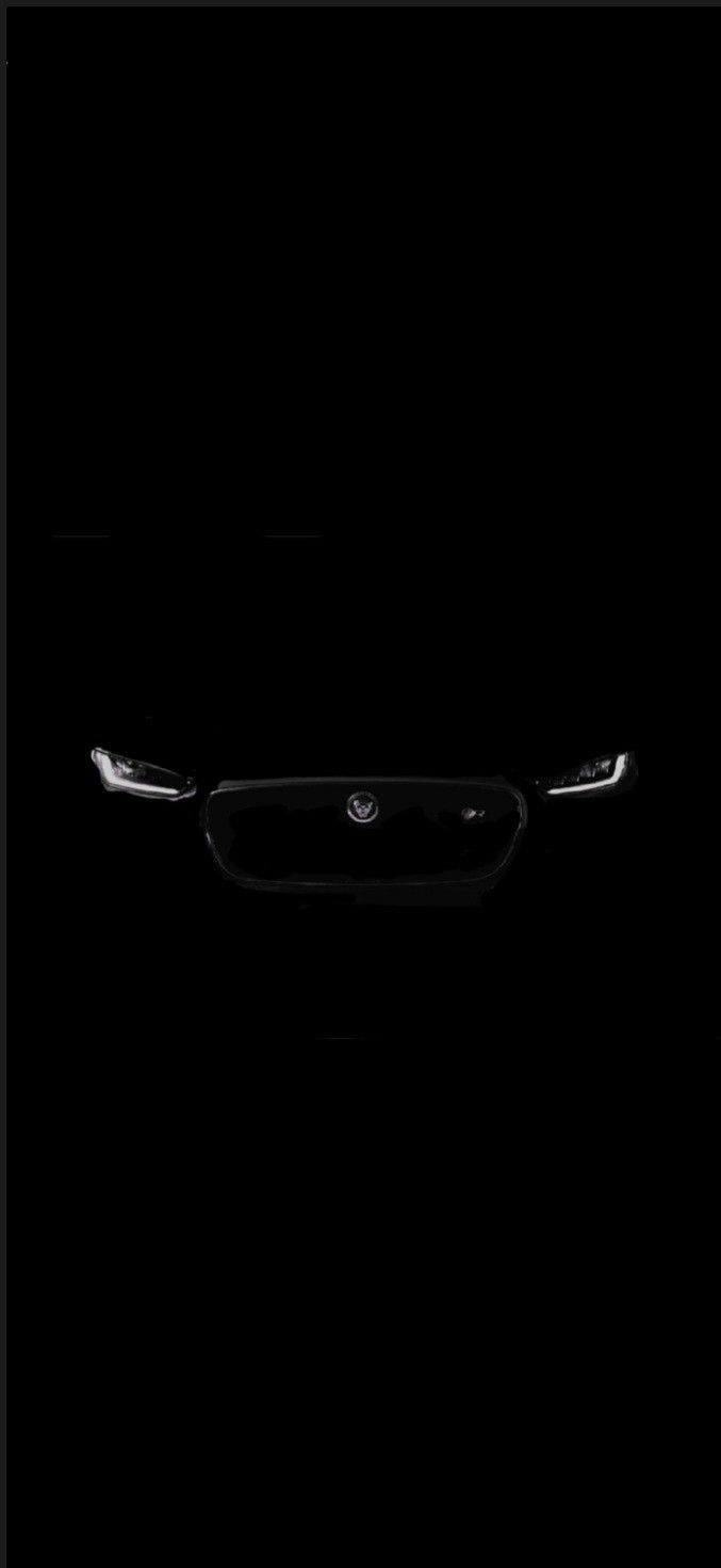 the front end of a car in the dark