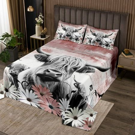 a bed with a cow and flowers on it