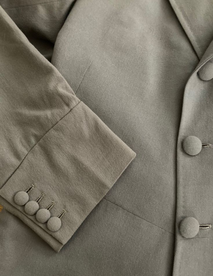 "Well tailored double breasted wool coat by Morty Sills has covered buttons in the front, on the cuffs and in the back. Coat is lined in a taupe satin and has two inside pockets, slight shoulder pads and a back kickpleat. In excellent vintage condition The Morty Sills brand has been referred to as \"the tailor to the CEO\". Morty Sills specialized in high-end formal/semi-formal wear for men and women. Handcrafted in the USA. Shoulders 17\" Chest 40\" Waist 36\" Hips 42\" Length from back of neck Classic Double-breasted Suit With Button Cuffs, Classic Double-breasted Suits With Button Cuffs, Elegant Long Sleeve Gabardine Blazer, Elegant Notch Lapel Gabardine Blazer, Elegant Gabardine Blazer With Notch Lapel, Beige Double-breasted Suit With Buttons, Beige Double-breasted Suits With Buttons, Formal Gabardine Blazer With Long Sleeves, Formal Long Sleeve Gabardine Blazer