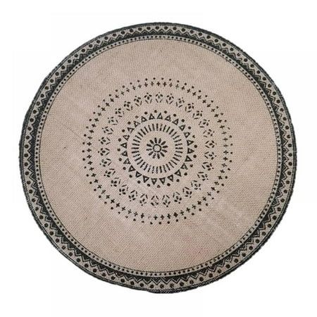 a round rug with black and white designs on it