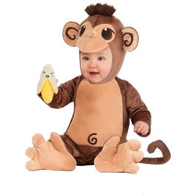 a baby in a monkey costume holding a banana