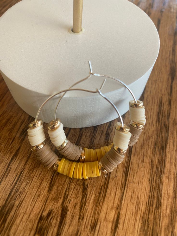 Silver 🌿Bohemian Style Hoops Creating handmade unique meaningful jewelry pieces designed to inspire you! Visit my shop https://Create2inspireOne.Etsy.com  🌟Details & Material:  *Silver Hoop Earrings  *Heishi Clay Beads mixed: beige, tan & mustard  *Gold flat focal beads *Earring Card included  *Silicone Backs included  *Jewelry Box Included  Create2inspireOne jewelry makes for a special occasion, great birthday gift, a friend, loved one,  anniversary gift- the shock on your partners face when Handmade Adjustable Small Hoop Earrings, Bohemian Yellow Hoop Earrings, Adjustable Single Wrap Bohemian Earrings, Bohemian Adjustable Single Wrap Earring, Adjustable Bohemian Single Wrap Earring, Adjustable Single Bohemian Wrap Earring, Adjustable Festival Hoop Earrings With Ear Wire, Adjustable Brown Hoop Earrings, Bohemian Adjustable Nickel-free Wrap Earrings