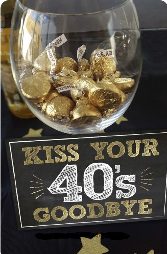 a sign that says kiss your 40's goodbye in front of some gold coins