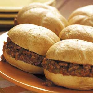 several hamburgers sitting on top of a plate with buns in the middle,