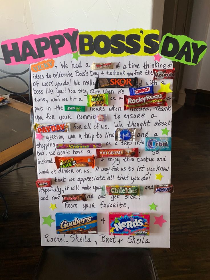 a sign that says happy boss's day with candy bars on the front and back