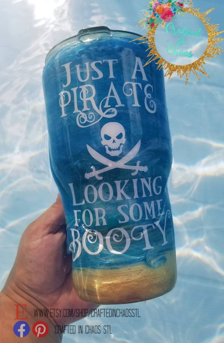 a hand holding up a blue water bottle that says just a pirate looking for some booy