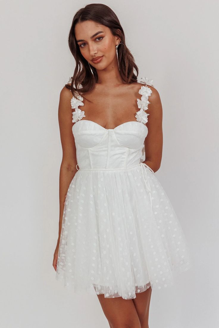 Flared mini dressRosette strapsSweetheart necklineBust paddingCorset boningWaist tieLiningInvisible back zipper You'll feel like a princess in our gorgeous Fairytale Dream mini dress. Featuring the sweetest floral embellishment on the straps and a polka dot mesh, it's perfect for bridal events or birthday celebrations. Team it with white heels and get ready to be swept off your feet.MODEL INFOModel is wearing size XSHeight: 5'8"Bust: 31.0"Waist: 24.0"Hips: 35.0"CAREHand Wash Cold. Do Not Iron.MATERIALPOLYESTER Pink Dress Shoes, Bridal Events, Floral Embellishment, Corset Boning, Selfie Leslie, Brunch Dress, Yellow Bridesmaids, Mini Dress White, Bridal Event