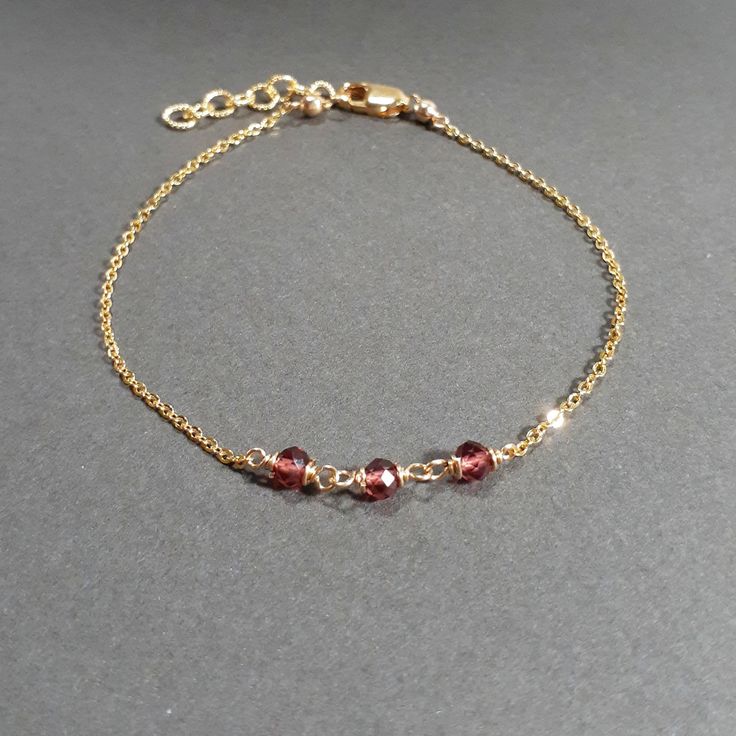 This beautiful handmade bracelet features 3 Genuine Garnets wrapped in 14k Gold Filled or Sterling Silver. Dainty, minimal, and elegant, this bracelet is the perfect finishing touch to any style or event. Wear this beautiful handmade bracelet alone or stacked with others. Makes a great gift to add to any gemstone lover's collection. Perfect to gift for Christmas, Valentine's Day, Mother's Day, and more! Gemstone: Garnet Bead Size: 3.0 mm Gemstone Shape: Rondelle, Faceted Metal: 14k Gold Filled o Elegant Rose Gold Hand Wrapped Jewelry, Elegant Stackable Beaded Bracelets In 14k Gold, Elegant 14k Gold Hand Wrapped Jewelry, Elegant Hand-wrapped 14k Gold Jewelry, Elegant Hand Wrapped 14k Gold Jewelry, Minimalist 14k Gold Bracelets For Party, Elegant 14k Gold Filled Hand-wrapped Bracelets, Elegant Hand Wrapped Gold Beaded Bracelets, Elegant Adjustable 14k Gold-filled Beaded Bracelet