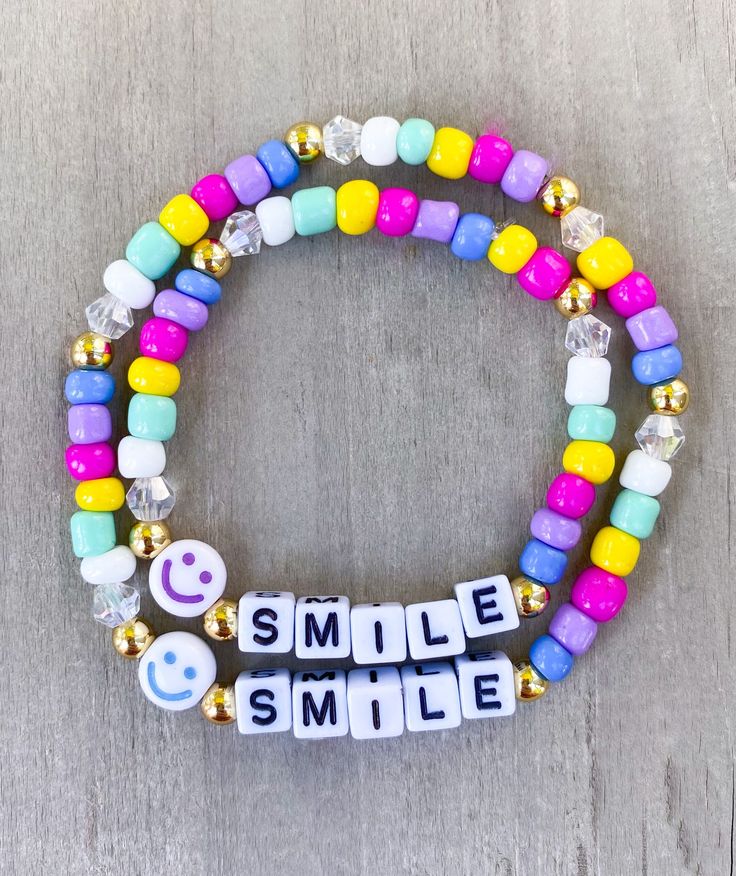 "Mother and Daughter Bracelet Set Let your daughter know you are thinking about her with this cute set Made with multi colored seed beads, clear bicone beads, 18k gold filled beads, smile bead and 4mm square letters that read \"smile\" Please put sizing in Personalization Section Personalize this listing with another word or color, please put in Personalization Section* CARING TIPS FOR YOUR JEWELRY ⭐️Treat and store with care. ⭐️ For longevity, avoid exposing your jewelry to water. ⭐️ Avoid having direct contact with lotions, perfumes, sanitizers as these chemicals may cause discoloration of your jewelry." Novelty Friendship Bracelets With Letter Beads As Gift, Novelty Letter Beads Friendship Bracelet As Gift, Cheerful Adjustable Friendship Bracelets As Gift, Cute Name Bracelet With Letter Beads As Gift, Playful Beaded Bracelets For Mother's Day Gift, Cute Letter Beads Name Bracelet As Gift, Playful Customized Everyday Jewelry, Cute Bracelets For Mother's Day, Novelty Bracelets With Letter Beads For Birthday