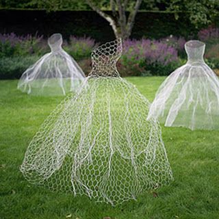 three mannequins made out of netting in the grass