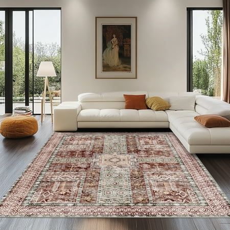 a living room filled with furniture and a large rug on top of a hard wood floor