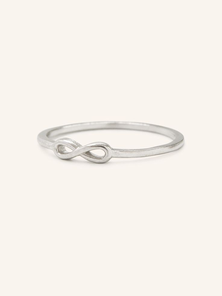 Petite and minimal, a beautiful infinity love ring that can be stacked with your favorite rings. Modern Twist Infinity Stackable Rings As Gift, Infinity Shaped Stackable Promise Ring Jewelry, Stackable Infinity Promise Ring, Modern Twist Infinity Stackable Rings, Adjustable Infinity Stackable Rings With A Modern Twist, Infinity Stackable Rings For Wedding, Infinity Stackable Wedding Rings, Sterling Silver Infinity Stackable Rings, Adjustable Infinity Promise Ring