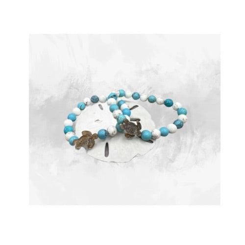 Dive into a sea of elegance with our handcrafted Turquoise Blue Turtle Bracelet. Each 8mm turquoise bead, reminiscent of serene ocean waves, is carefully strung to create a captivating flow of colour. The star of the show is its signature pearl turtle charm, meticulously carved to reflect the majestic beauty of sea turtles. With each detail reflecting the charm of ocean life, this one-of-a-kind bracelet evokes a sense of tranquillity and adventure. Its durable elastic design ensures a comfortable fit, while its unique turtle charm adds a touch of whimsy to any outfit. Whether you're a lover of ocean life or just a fan of unique, artisan jewelry, this turquoise turtle bracelet is a must-have addition to any jewelry collection. Each bracelet is individually crafted, assuring you hold a uniqu Turquoise Gemstone Beads Bracelet For Beach, Turquoise Gemstone Beaded Bracelets For Beach, Blue Hand Wrapped Beaded Bracelets, Beach Jewelry With 8mm Blue Beads, Ocean-inspired Turquoise Bracelets As Gift, Ocean-inspired Turquoise Beaded Bracelets For Gift, Turquoise Round Bead Jewelry For Beach, Turquoise Gemstone Beads Bracelets For Beach, Turquoise Ocean-inspired Bracelets As Gift