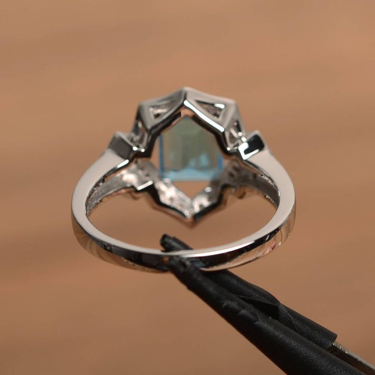 It is a Swiss blue topaz ring. The main stone is 6 mm*8 mm emerald cut.weight about 2.01 carats The basic metal is sterling silver and plated with rhodium. To change the metal to a solid gold (white/rose) or platinum is also available, please ask for a quotation if you want. You can also go to my shop Home for more elegant rings: https://www.etsy.com/shop/godjewelry?ref=hdr_shop_menu Swiss blue topaz is November birthstone More Swiss blue topaz rings: https://www.etsy.com/shop/godjewelry?search_ Rainbow Topaz Ring, Blue Topaz Rings, Topaz Rings, Elegant Rings, Swiss Blue Topaz Ring, Rainbow Topaz, Ring Emerald Cut, June Birthstone Ring, Silver Engagement Ring