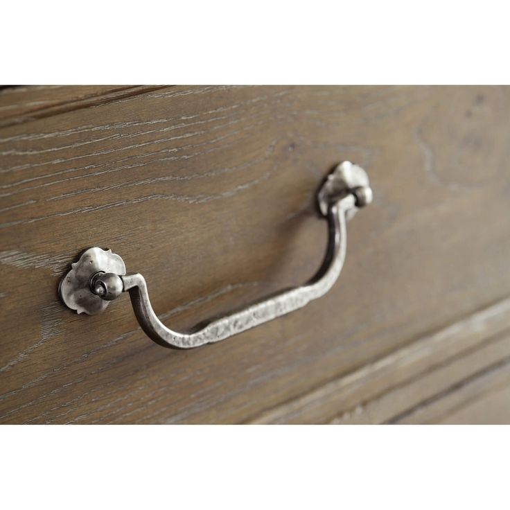 an old wooden drawer with a metal handle on it