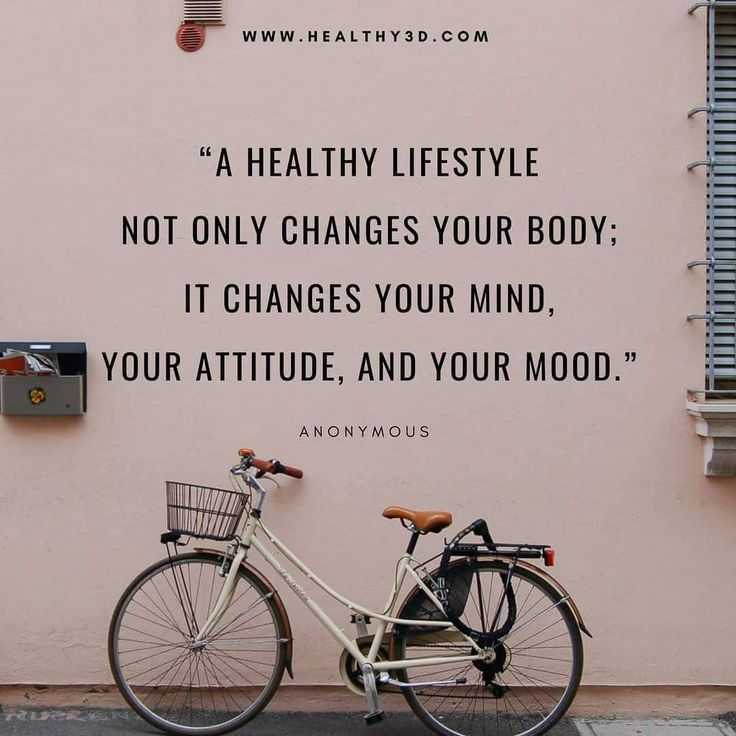 a bicycle parked next to a pink wall with a quote written on it that reads, healthy lifestyle not only changes your body