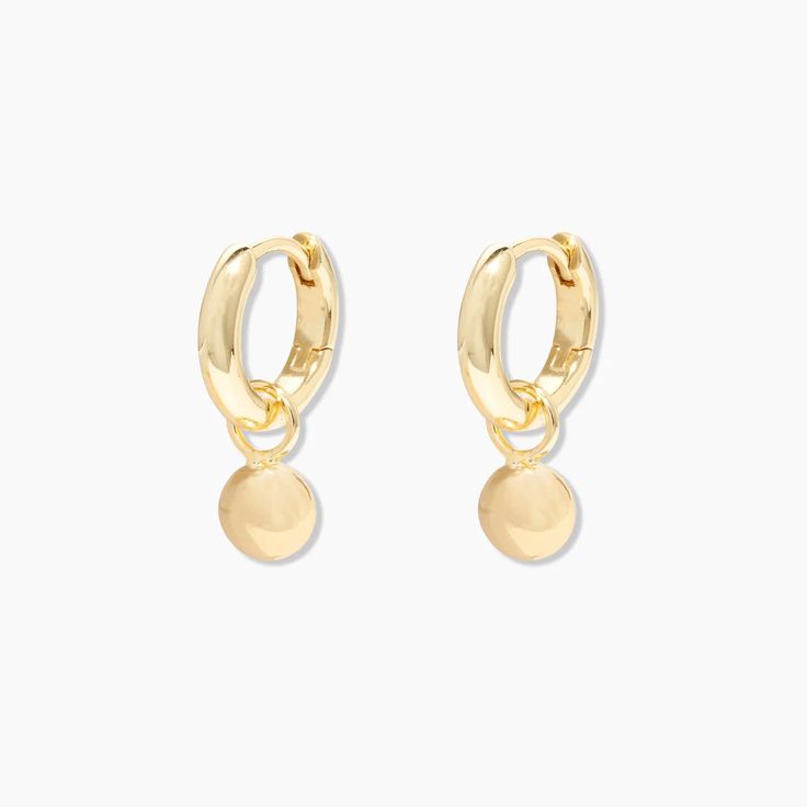 This drop earring features a chic huggie with an attached gold bead that moves with you. This earring is the perfect simple statement. 1/2" profile diameter 1/8" wide Charm diameter 1/4" Hinge post closure Available in 18k gold plated brass Avoid contact with anything containing derivatives of alcohol Gold Plated Dangle Huggie Earrings For Everyday, Tarnish Resistant Gold Dangle Huggie Earrings, Tarnish-resistant Gold Dangle Huggie Earrings, Gold Tarnish-resistant Dangle Cartilage Earrings, Gold Hypoallergenic Dangle Cartilage Earrings, Gold-plated Dangle Huggie Earrings, Gold Dangle Huggie Earrings For Pierced Ears, Gold Dangle Huggie Earrings, Minimalist Gold Plated Drop Huggie Earrings