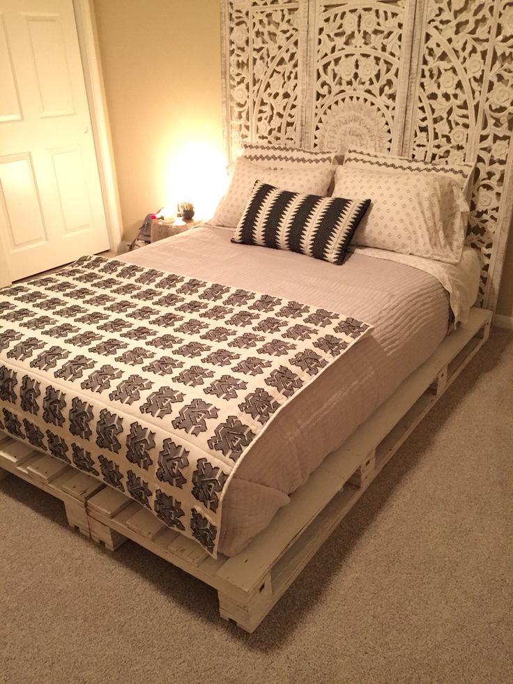 a bed made out of pallets in a bedroom