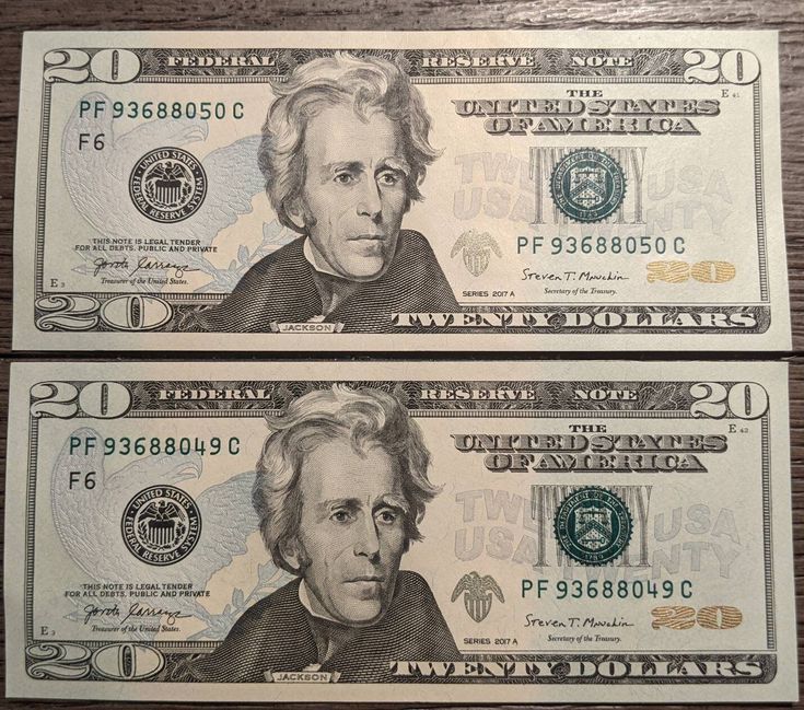 two twenty dollar bills are shown in this image