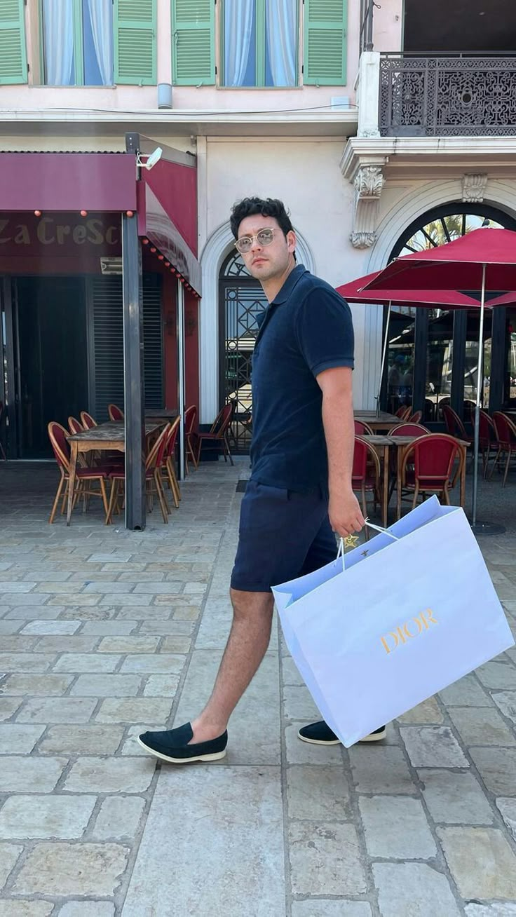 a man walking down the street carrying shopping bags