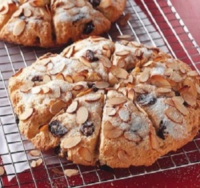 two cookies with almonds are on a cooling rack