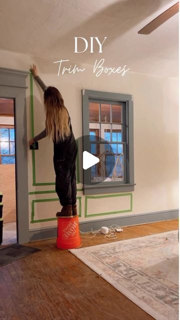 a woman standing on top of a red bucket in front of a window with the words diy trim boxes