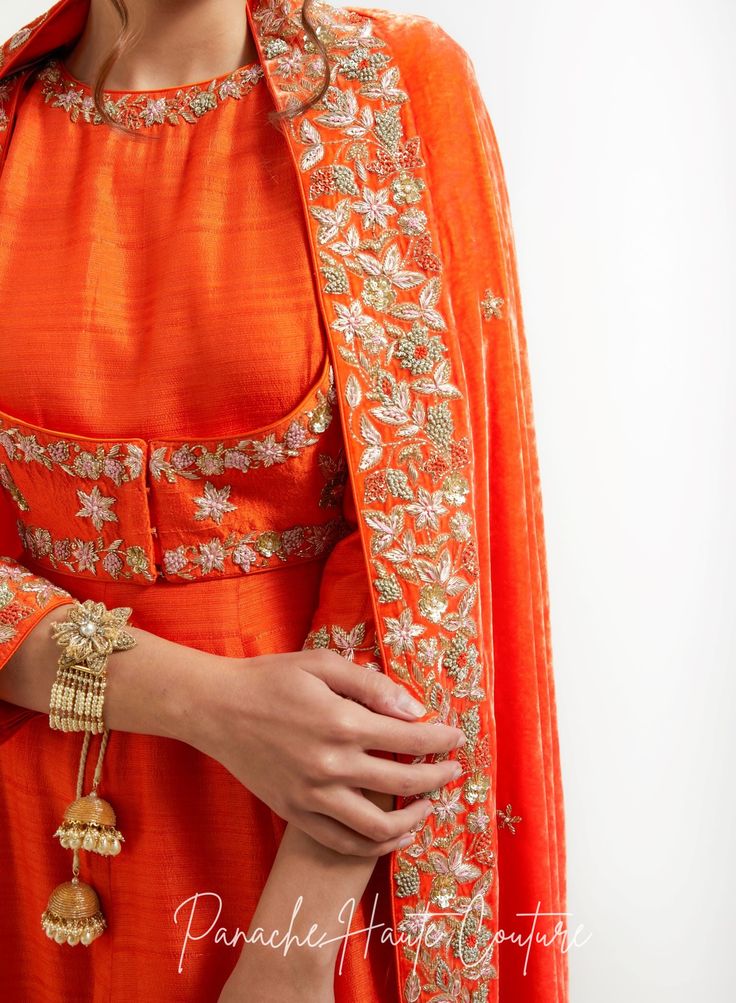 An orange silk velvet shawl with zardozi embroidery is a stunning and vibrant accessory that is perfect for adding a touch of luxury and elegance to any outfit. Silk velvet is a plush and soft fabric that has a subtle sheen, while zardozi embroidery is an intricate and traditional style of Indian embroidery that involves metallic threads and beads. Styling Tips: When styling an orange silk velvet shawl with zardozi embroidery, it's important to let the shawl be the focal point of the outfit. Pair it with neutral colors such as black or white to make the vibrant orange color stand out. Alternatively, you can pair it with complementary colors such as gold, yellow, or red for a bold and striking look. The zardozi embroidery on the shawl adds texture and visual interest, making it an ideal acc Velvet Shawls, Zardozi Embroidery, Curated Outfit, Velvet Shawl, Saree Gown, Embroidery Materials, Types Of Embroidery, Indian Embroidery, Complementary Colors