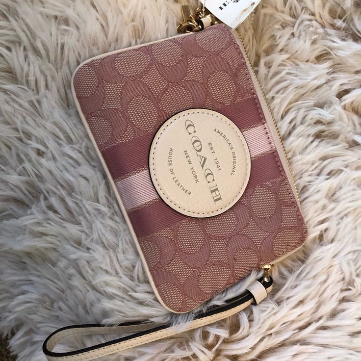 Coach Boxed Dempsey Corner Zip Wristlet In Signature Jacquard With Coach Patch And Stripe. Also Includes Charms. See The Following Description: Signature Jacquard And Refined Pebble Leather Two Credit Card Slots Zip-Top Closure, Fabric Lining Wrist Strap Attached 6 1/4" (L) X 4" (H) X 1/2" (W) Includes Removable Charms Pink Wristlet With Removable Pouch As Gift, Pink Wristlet With Zipper Closure As Gift, Pink Clutch Wristlet With Zipper Closure, Elegant Pink Bag With Wrist Strap, Pink Rectangular Bag With Wrist Strap, Pink Wallet With Wrist Strap As Gift, Elegant Pink Coach Wristlet, Pink Pouch Clutch With Wrist Strap, Pink Pouch Wristlet With Strap