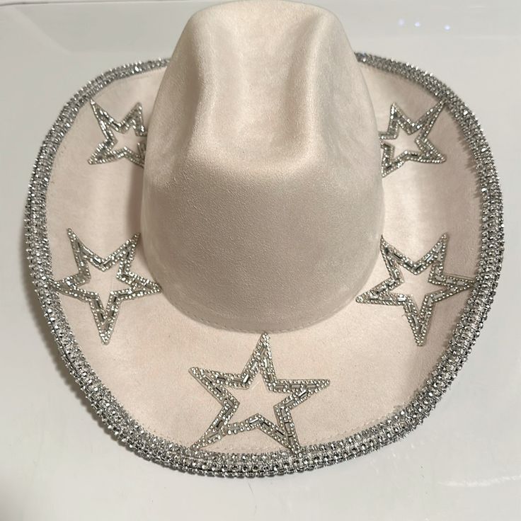 Nwt Star Studded Cowgirl Hat A Vibrant Cream Cowgirl Hat Adorned With Star Shimmering Rhinestone Star Shapes. Crafted From High Quality Polyester, This Hat Offers Both Style And Durability For Any Cowgirls Adventures. This Hat Offers A Touch Of Glamour And Western Charm Making This Hat A Standout For Rodeos, Festivals, Concerts, Or Everyday Wear. Absolutely Stunning! Quick Shipping Checkout My Other Listings I Accept Reasonable Offers Sparkly Cowboy Hat, Rhinestone Cowgirl Hat, Cosmic Cowgirl, Rhinestone Cowgirl, Boho Cowgirl, Cowgirl Hat, Cowgirl Hats, Charm Making, Star Studs