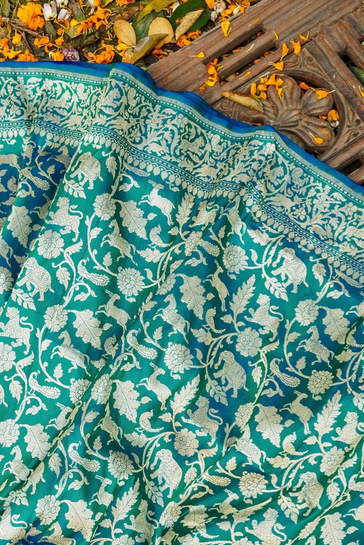 Embodying Indian craftsmanship and heritage, the Handwoven Katan Silk Banarasi Shikargah Saree is a dazzling choice for any occasion. Crafted from the finest Katan silk, this exquisite garment features intricate floral motifs handwoven in vibrant colors, inspired by the beauty of nature. Click here to view the underskirt Traditional Katan Silk Embroidered Fabric, Traditional Handloom Katan Silk Embroidered Fabric, Traditional Katan Silk Handloom Fabric, Semi-stitched Katan Silk Embroidered Fabric, Semi-stitched Katan Silk Fabric, Latest Bridal Lehenga Designs, Silk Banarasi Saree, Bridal Lehenga Designs, Latest Bridal Lehenga