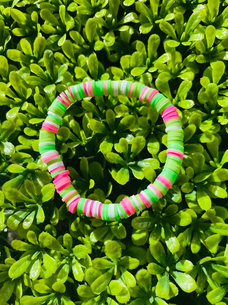 A pink, green, and white clay bead bracelet that is unique but also simple enough to wear with any outfit! *All bracelets are 6.5 - 7 inches, but if custom size is needed, please leave a message or add a note*   You can also mix and match with other bracelets from my shop to create a bracelet stack that suits your style:) All bracelets are.... --------------------------- - Comfortable  - Durable - Stretchy - Colorful - Waterproof ---------------------------- Please contact me at baforsyt11@gmail.com if bracelets arrive damaged or is too small/big. Also feel free to contact me if you would like a custom size, colors, design, or name added to the bracelet:) ( no extra charge )  CARE TIPS ----------------------------------------------------------- - Roll or lightly stretch to get of wrist - D Fun Green Beaded Bracelets, Fun Green Beaded Bracelets With Round Beads, Green Fun Friendship Bracelets With Colorful Beads, Fun Green Friendship Bracelets With Colorful Beads, Playful Green Friendship Bracelets With Colorful Beads, Fun Green Friendship Bracelet With Colorful Beads, Playful Green Beaded Friendship Bracelets, Fun Green Bracelets With Round Beads, Fun Green Round Beads Friendship Bracelets