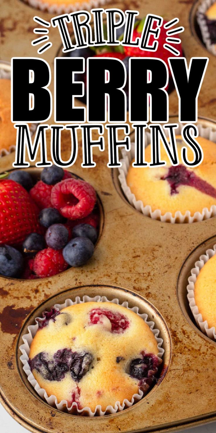 blueberry muffins with berries and raspberries in the middle on a baking sheet