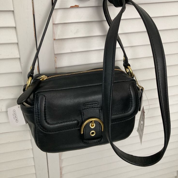 This Bag Is Brand New With Tag Attached It Is Style Number F25150 Leather Crossbody Camera Bag Original Retail $258 It Has A Flap In Front With Magnetic Snap Closure, It Has A Zip Top Opening With An Inner Zip Pocket And Two Open Side Pockets. Dimensions Are Approx 8.5 X 5 X 4 With Strap Drop Length Of 25 In Square Flap Bag With Branded Hardware For Travel, Square Bag With Branded Hardware For Everyday Use, Classic Rectangular Bag With Branded Hardware, Classic Rectangular Bags With Branded Hardware, Classic Satchel Box Bag With Branded Hardware, Travel Satchel Box Bag With Branded Hardware, Square Bags With Branded Hardware, Classic Black Flap Bag For Shopping, Black Flap Bag With Branded Hardware For Shopping