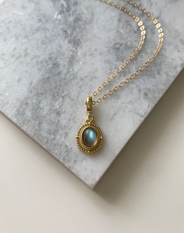 ✦ MATERIALS Pendant: Labradorite / 14k Gold Filled Chain: 14k Gold Filled ✦ SIZE Pendant: Approximately 1/2 inch tall/wide ✦ What is Gold Filled? Unlike gold plated items which have a negligible amount of gold content, gold filled contains a minimum of 5% (1/20) gold by weight pressure bonded over brass. They are tarnish resistant and perfect for those with allergies or sensitive skin. Gold-filled jewelry has 100x more gold alloy than gold plated and because that layer is so much thicker, it mea Gold Labradorite Jewelry With Birthstone, Gold Labradorite Birthstone Jewelry, Gold Oval Pendant Necklace In Labradorite, Gold Labradorite Oval Pendant Necklace, Elegant Gold Necklace With Labradorite, Elegant Gold Labradorite Necklace, Elegant Labradorite Necklaces With Birthstone, Elegant Labradorite Oval Pendant Necklace, Gold Oval Labradorite Necklaces