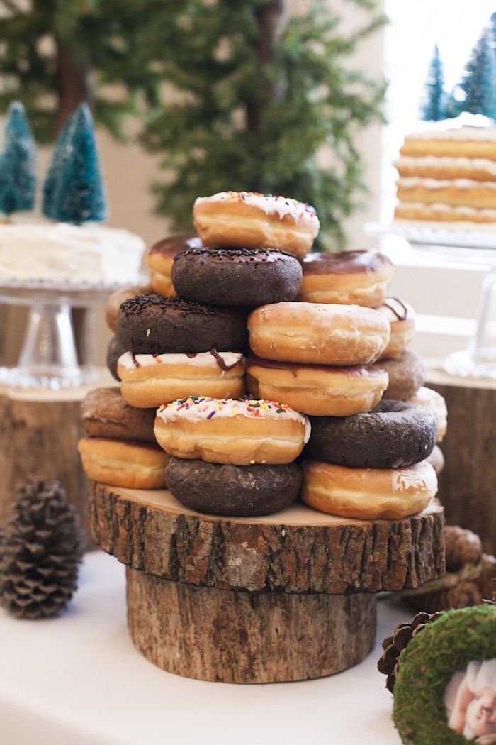 a stack of doughnuts sitting on top of a tree stump