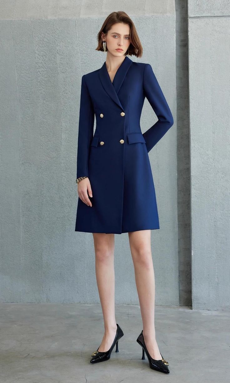 Exude Confidence with the Navy Double-Breasted Blazer Dress Step into a world of refined elegance with our Navy Double-Breasted Blazer Dress—the epitome of power dressing for the modern woman. This dress combines the sharp tailoring of a blazer with the femininity of a dress, creating a look that is both authoritative and elegant. Crafted from high-quality fabric, it features a sleek navy hue, structured shoulders, and gold-tone buttons that add a touch of luxury. The long sleeves and tailored f Elegant Double-breasted Jacket Dress For Spring, Fitted Knee-length Winter Blazer Dress, Fitted Knee-length Blazer Dress For Winter, Elegant Fitted A-line Blazer Dress, Elegant Structured Blazer Dress With Buttons, Elegant A-line Midi Dress With Button Closure, Structured Fitted Blazer Dress With Buttons, Formal Tailored A-line Midi Dress, Elegant Fitted Structured Blazer Dress