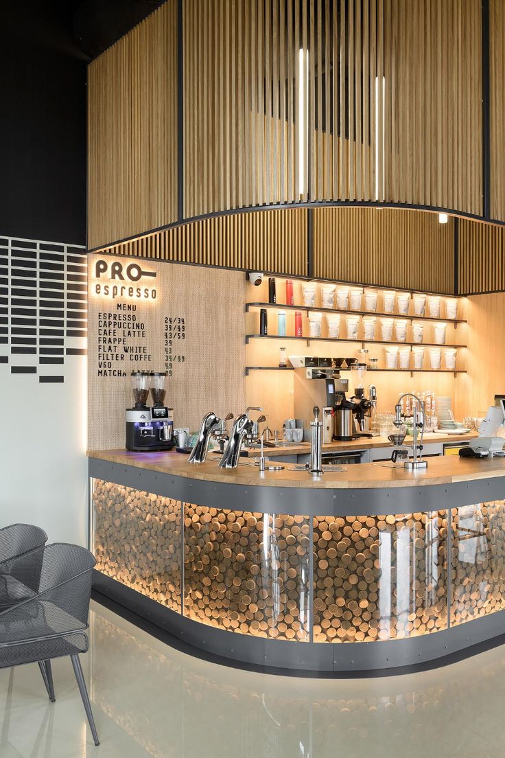 a restaurant counter that is made out of wood and has metal bars on the top