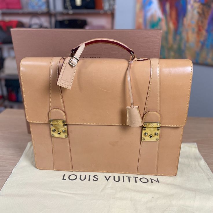 Louis Vuitton 100% Guaranteed Authentic Made In France Briefcase In Tan Vachetta Leather Includes Luggage Tag And Clochette With Keys + Box And Dust Bag By Louis Vuitton *Dust Bag & Box May Show Light Wear Retail Above $6k Ebay Will Authenticate This For You As A Complementary Service Before You Receive It And Will Also Provide You With A Heavy Weight Luxurious Ebay Dust Bag. Rare And Highly Collectible Louis Vuitton Tan Vachetta Leather Briefcase. Crafted From Luxurious Cowhide Vachetta Leather That Develops A Rich Patina Over Time, It Features Exquisite Brass Hardware And Meticulously Designed Compartments. Ideal For The Successful Businessman Who Values Timeless Elegance And Sop Designer Rectangular Briefcase With Gold-tone Hardware, Luxury Brown Briefcase With Gold-tone Hardware, Designer Briefcase With Gold-tone Hardware, Designer Brown Briefcase With Gold-tone Hardware, Luxury Business Briefcase With Gold-tone Hardware, Brown Briefcase With Gold-tone Hardware For Business, Designer Briefcase With Gold-tone Hardware For Daily Use, Brown Business Briefcase With Gold-tone Hardware, Luxury Travel Briefcase With Gold-tone Hardware