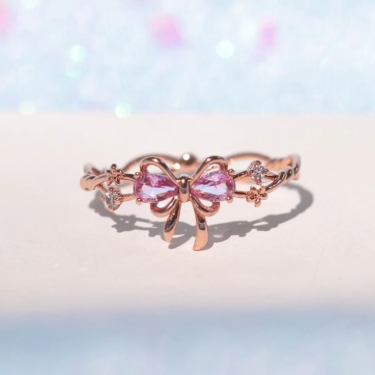 This ring will get you feeling extra pretty in pink! Wrap yourself up in a bow and celebrate the greatest present there is--you! Featuring a delicate intertwining band and dazzling embellishments, all leading to a perfect pink ribbon. This piece will make you feel like the ultimate gift! 18k gold plated, 18k rose gold Pink Ribbon Jewelry As Gift, Pink Ribbon Jewelry Gift, Gift Jewelry With Pink Bow, Pink Ribbon Jewelry For Gifts, Valentine's Day Gift Jewelry With Pink Bow, Rose Gold Jewelry With Bow For Gifts, Pink Bow Jewelry For Anniversary, Pink Ribbon Jewelry For Party, Pink Bow Jewelry For Valentine's Day Party