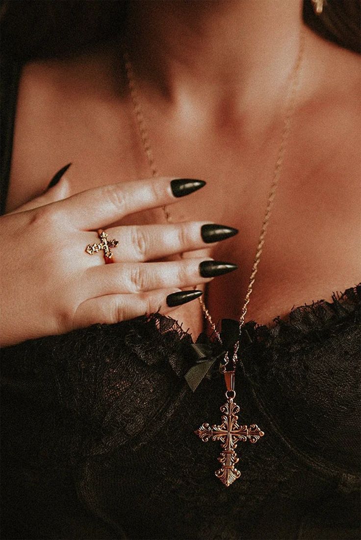 The Lament Gold Cross Necklace is adorned with the solemnity of a cross, a symbol of enduring significance. It is not just a necklace; it's a relic that resonates with the echoes of ancient times, recounting stories of timeless grace. Bathed in rich, opulent gold, this pendant captures the essence of both elegance and darkness. Its golden sheen is a reflection of the allure of the nocturnal, a reminder that beauty thrives even in the heart of the shadows. Size Info: Chain: 72cm Cross: 50mm. Stainless Steel 18k Gold Plaiting. Tarnish Resistant Spiritual Cross Jewelry, Gothic Gold Necklace With Clavicle Chain, Gothic Gold Cross Pendant Jewelry, Crucifix Clavicle Chain Jewelry Gift, Crucifix Clavicle Chain Jewelry For Gift, Spiritual Pendant Cross Necklace, Gothic Gold Engraved Jewelry, Gold Gothic Wedding Jewelry, Spiritual Cross Necklace As Gift