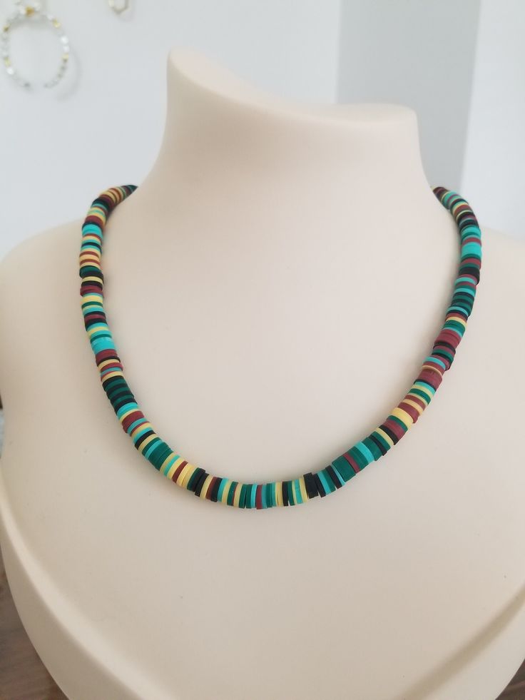 a necklace with multicolored beads on a white mannequin