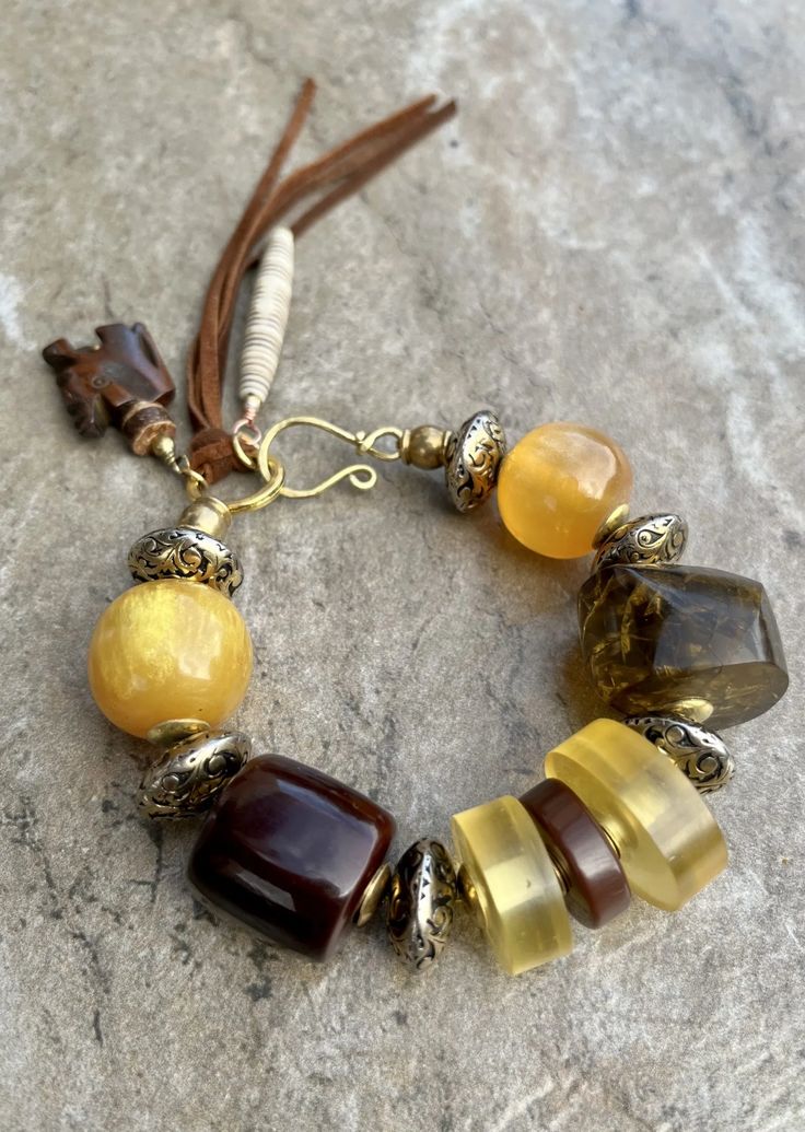 Bohemian Bracelet Vintage Resin, Antique Metal, Leather & African Trade Bohemian Hand-strung Amber Beaded Bracelets, Bohemian Amber Beaded Bracelets Hand-strung, Bohemian Amber Hand-strung Bracelets, Artisan Brown Beaded Bracelets With Large Beads, Bohemian Amber Beaded Bracelets With Round Beads, Bohemian Amber Beaded Bracelets, Rustic Brown Beaded Bracelets For Festival, Traditional Brown Beaded Bracelets For Beach, Bohemian Hand-strung Brown Beads