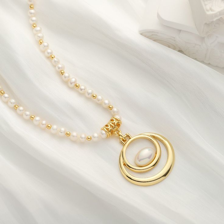 Adorn your neck with the remarkable elegance of our Oval Pearl Necklace. Crafted with 18k gold, this luxurious accessory will complete any ensemble with its timeless sophistication. With its alluring classic design, its sure to make a statement of timeless style. DETAILS Plating: 18K Gold Materials: 18K Gold on Brass, Freshwater Pearl Measurements: Length: 16.54"(42.0cm) + Extender: 2.36"(6.0cm) Weight:  36.59 g Elegant Gold Pearl Chain Necklace, Elegant Gold Plated Gold Pearl Necklace, Refined Gold Pearl Pendant Necklace, Refined Gold Pearl Necklaces, Elegant Gold Pearl Necklace With Charm, Refined Gold Necklace With Pearl Chain, Oval Gold Necklace With Pearl Chain, Refined Gold Necklace With Pearl Pendant, Gold Oval Pearl Necklace For Anniversary