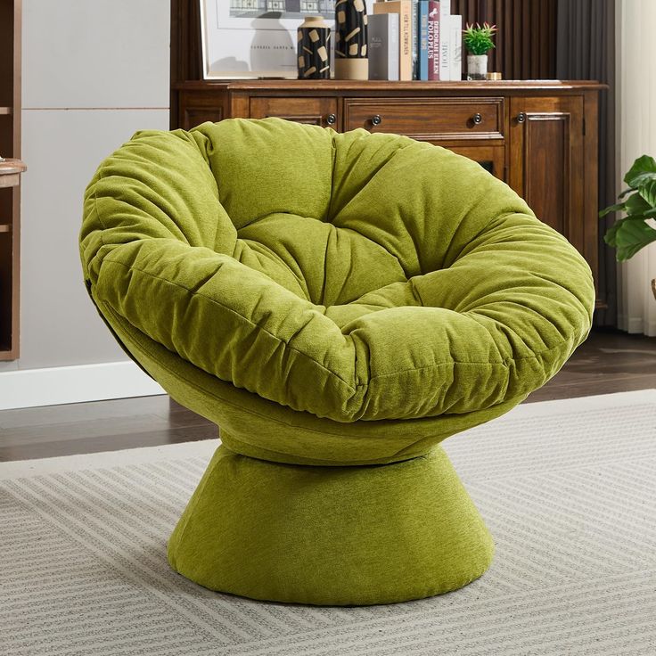 a green chair sitting on top of a white rug