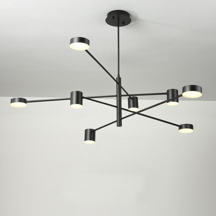 a black chandelier with six lights hanging from it's ceiling fixture in a room