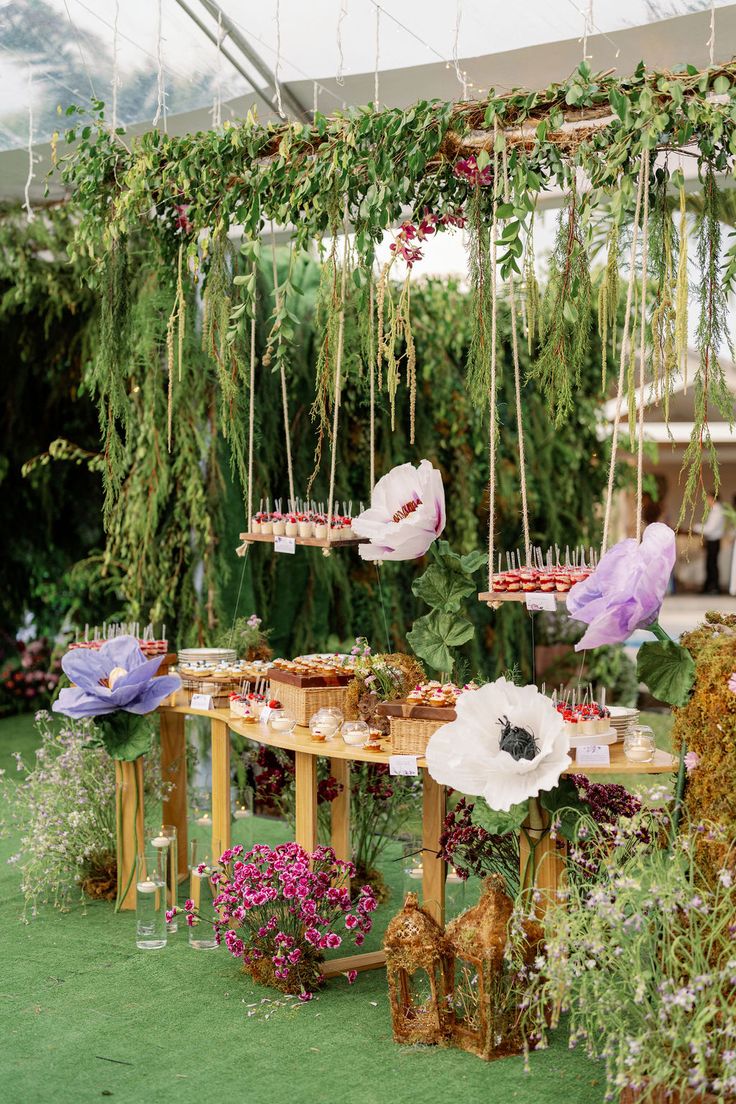 a table with flowers hanging from it's sides