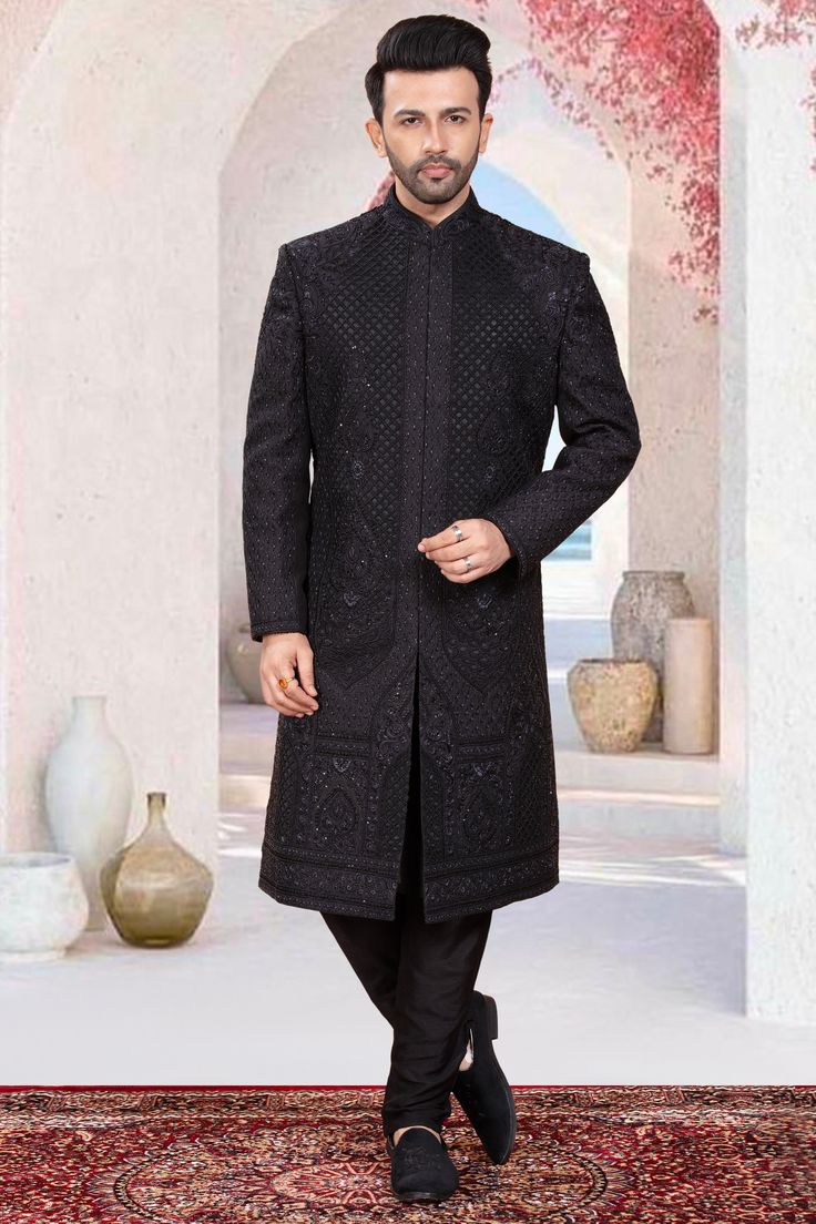 This exquisite mens sherwani is designed with intricate black bead embroidery, making it a must-have for grooms who want to make a bold statement on their special day. Perfectly blending traditional and modern styles, this sherwani exudes elegance and sophistication. Ideal for grooms who want to slay in black on their wedding day. Designer Sherwani For Reception In Winter, Traditional Black Bandhgala With Chikankari Embroidery, Designer Winter Sherwani For Reception, Designer Winter Reception Sherwani, Designer Sherwani With Intricate Embroidery For Winter, Designer Winter Sherwani With Intricate Embroidery, Black Kurta For Ceremonial Occasions During Transitional Season, Black Kurta For Ceremonial And Transitional Seasons, Black Chikankari Embroidery Sets For Reception