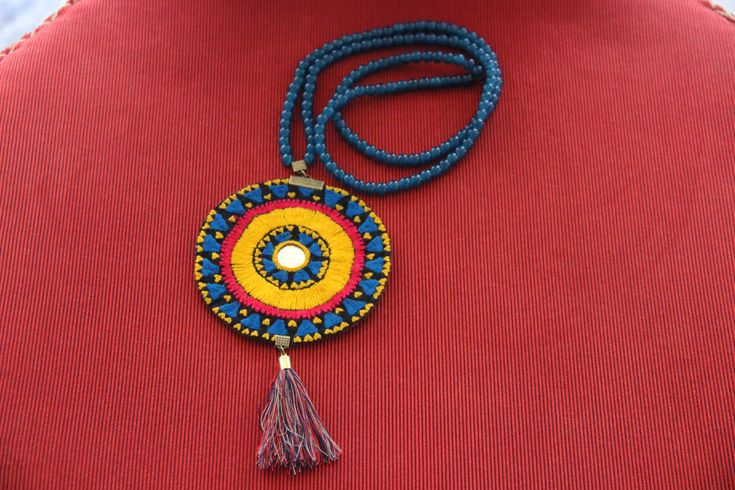 Embroidered Necklace with a long chain. Embroidery was an important and folk art in the Medieval Middle-Eastern world. It is one of the finest handcrafts-  hours are spent on making a small piece. The hard handwork behind each piece makes it priceless and stunning, becoming more and more popular in the western world.  In one of the small villages in the Middle-East, young girls have decided to bring about change and improvement. They make hand-made jewelry that has deep roots in their culture and history and spend the profit for the improvement of their small village. So far, they have been able to build a school and are hoping to expand their work and make it known to the world! Please join us in promoting their art and helping them reach their goal. Note that each and every one of the it Traditional Beaded Necklaces For Crafting Festivals, Handmade Beaded Necklaces For Rituals And Festivals, Traditional Beaded Chain For Crafting, Folk Style Handmade Jewelry As Gift, Handmade Folk Style Jewelry For Gifts, Handmade Folk Jewelry As Gift, Handmade Folk Style Jewelry Gift, Handmade Round Beaded Necklace For Festivals, Traditional Handmade Long Beaded Necklace