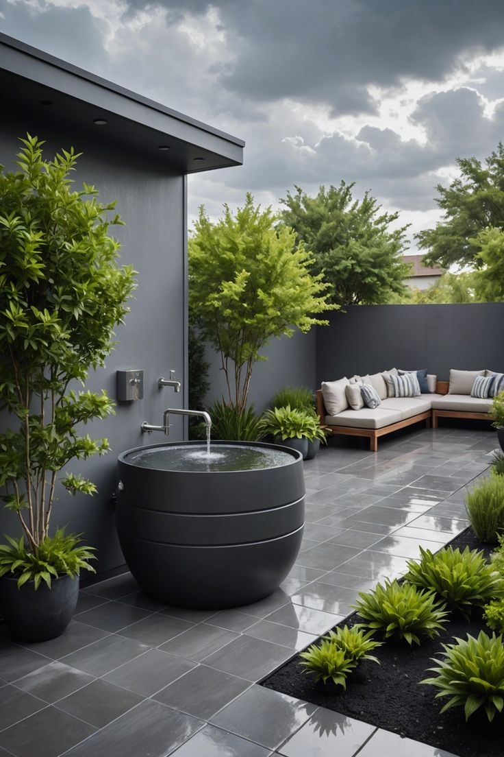 an outdoor bathtub in the middle of a patio with trees and plants around it