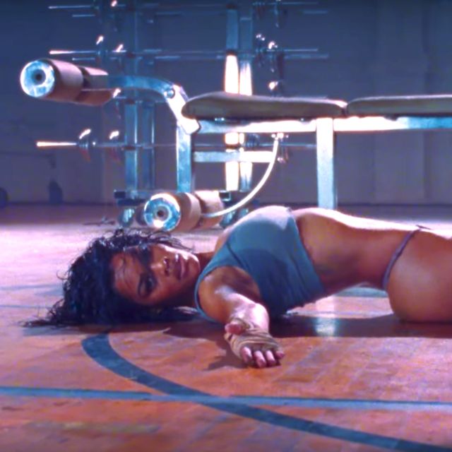 a woman laying on the ground in front of a gym machine